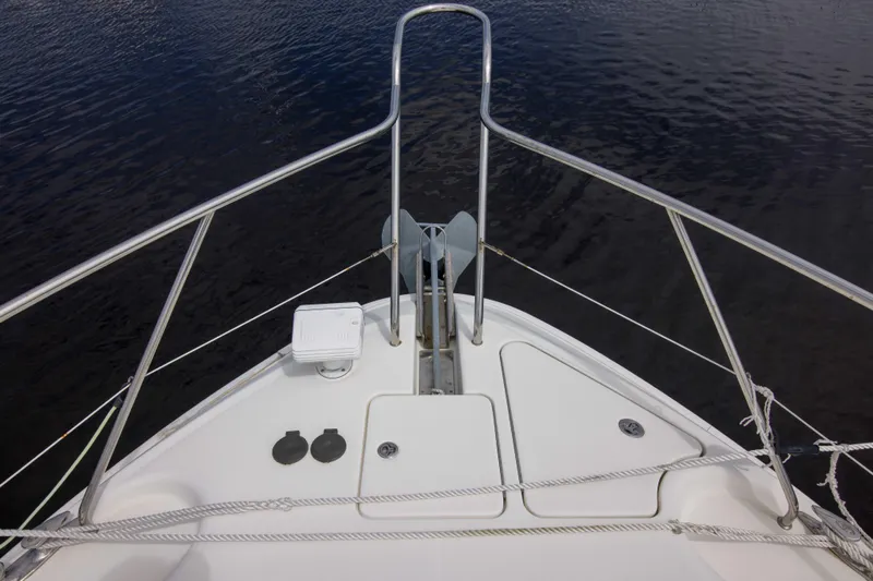 Immersed Yacht Photos Pics Bow of 2009 Silverton Oviation 52 yacht with railing and anchor, on calm water.