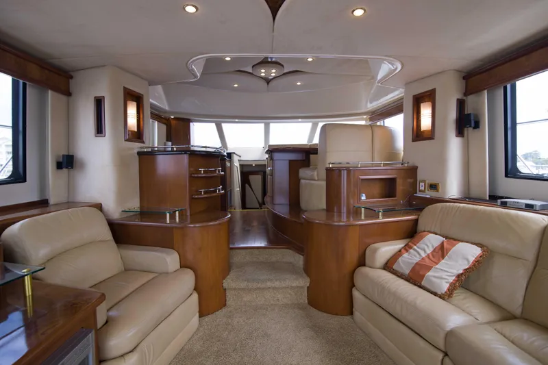 Immersed Yacht Photos Pics Luxurious interior of 2009 Silverton Oviation 52 yacht with plush seating and elegant wood finishes.