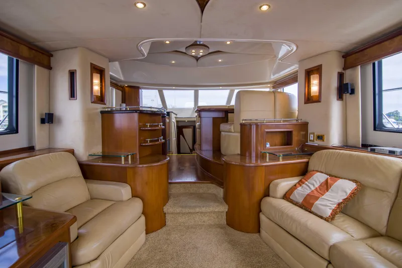 Immersed Yacht Photos Pics Luxurious interior of 2009 Silverton Oviation 52 yacht with plush seating and elegant wood finishes.