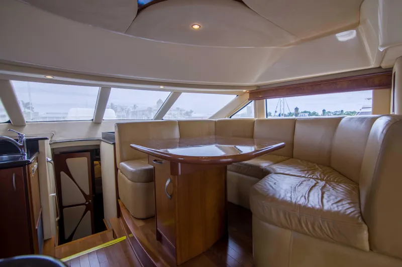Immersed Yacht Photos Pics Luxurious interior of 2009 Silverton Oviation 52 yacht with plush seating and wooden table.