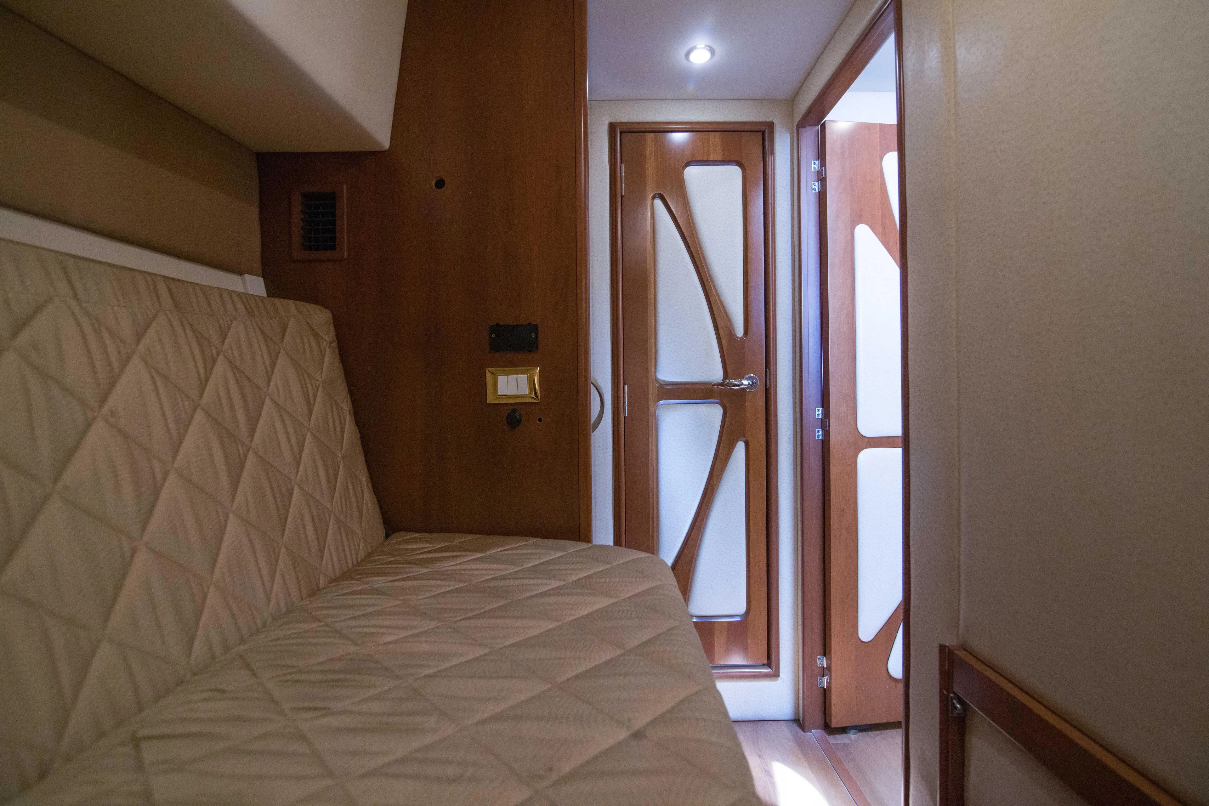 Immersed Yacht Photos Pics Interior of 2009 Silverton Oviation 52 yacht with quilted seating and modern wooden door.