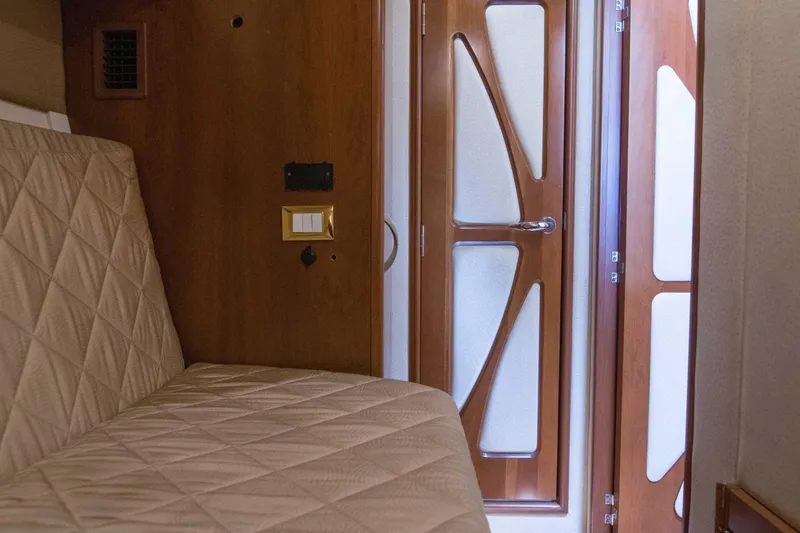 Immersed Yacht Photos Pics Interior of 2009 Silverton Oviation 52 yacht with quilted seating and stylish wooden door.
