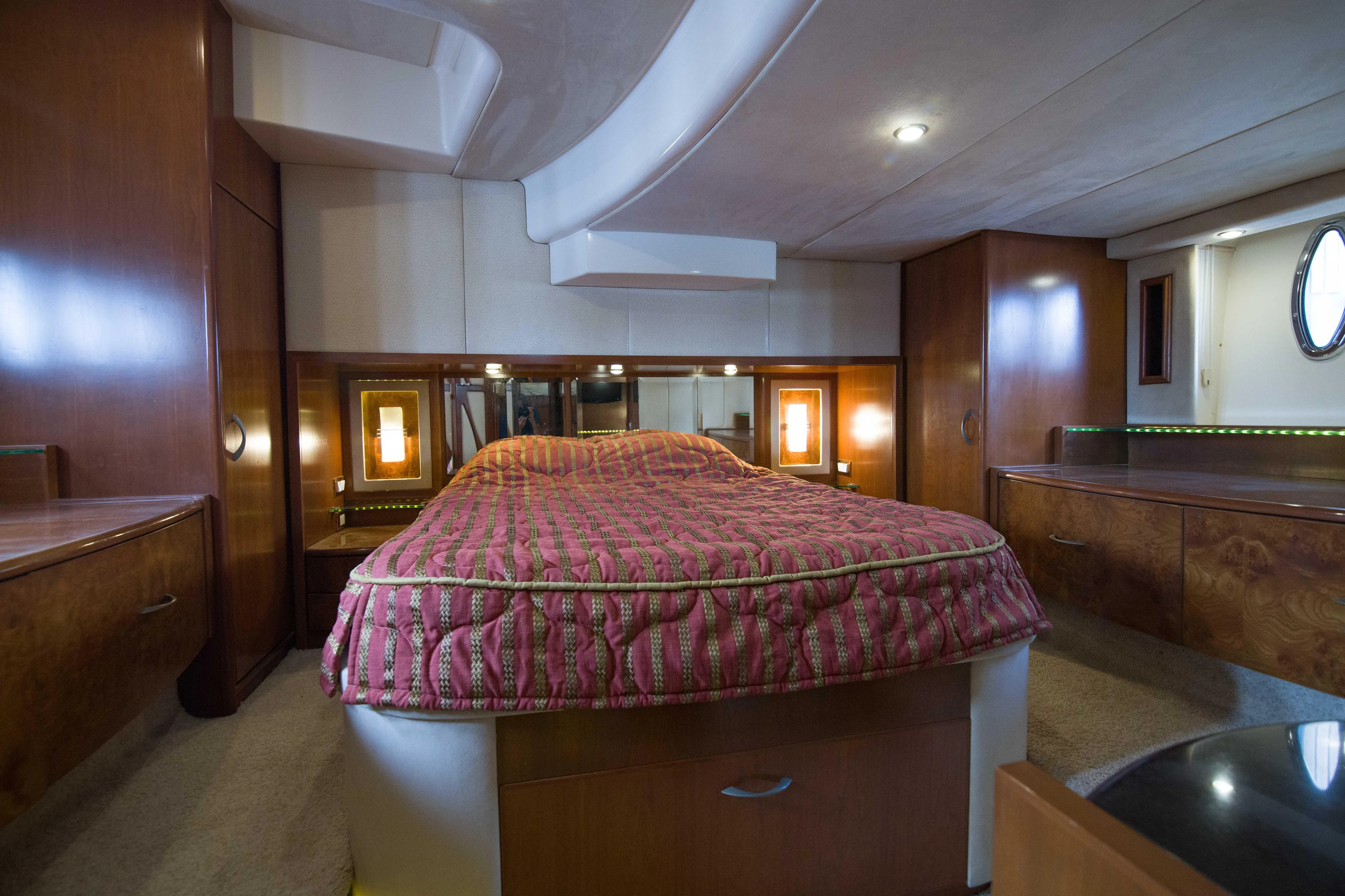 Immersed Yacht Photos Pics Luxurious bedroom interior of 2009 Silverton Oviation 52 yacht with elegant wood finishes.