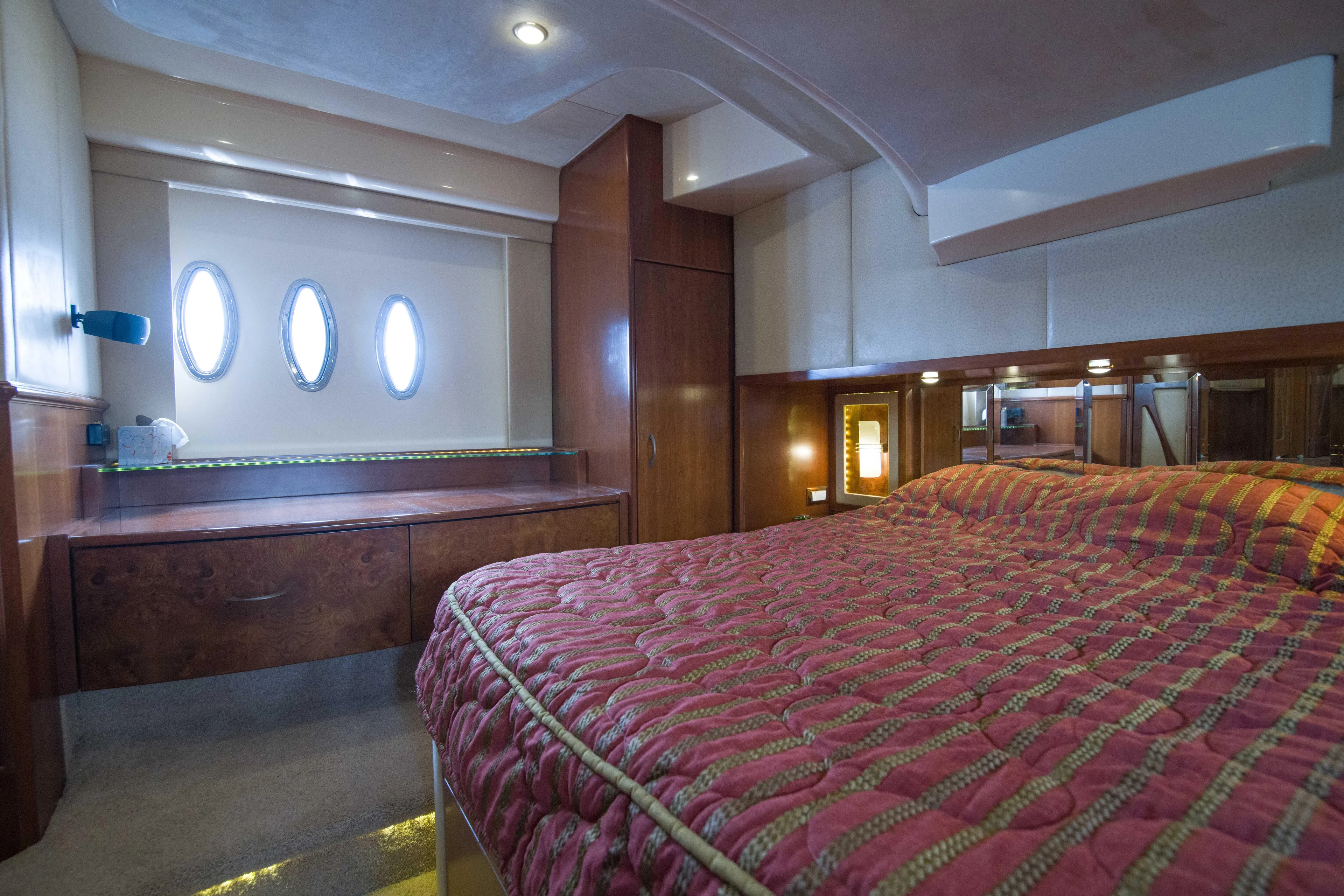 Immersed Yacht Photos Pics Luxurious bedroom interior of 2009 Silverton Oviation 52 yacht with elegant wood finishes.