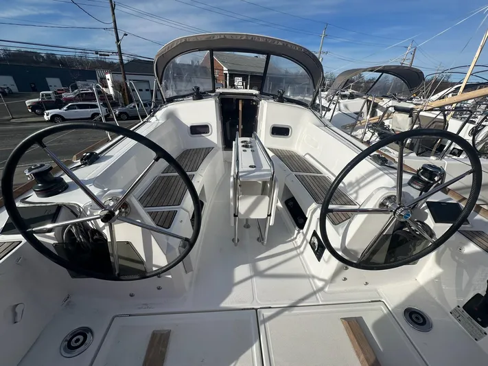  Yacht Photos Pics 2020 Jeanneau Sun Odyssey 349 sailboat cockpit with dual steering wheels and seating.