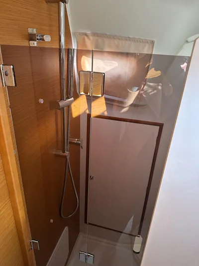  Yacht Photos Pics 2020 Jeanneau Sun Odyssey 349 shower area with modern fixtures and wooden accents.