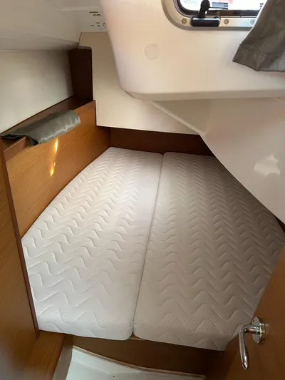  Yacht Photos Pics Cabin interior of 2020 Jeanneau Sun Odyssey 349 with twin beds and wooden finish.