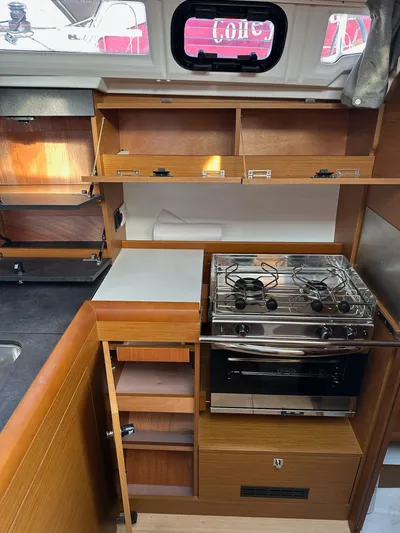  Yacht Photos Pics Interior of 2020 Jeanneau Sun Odyssey 349 yacht kitchen with stove and storage.