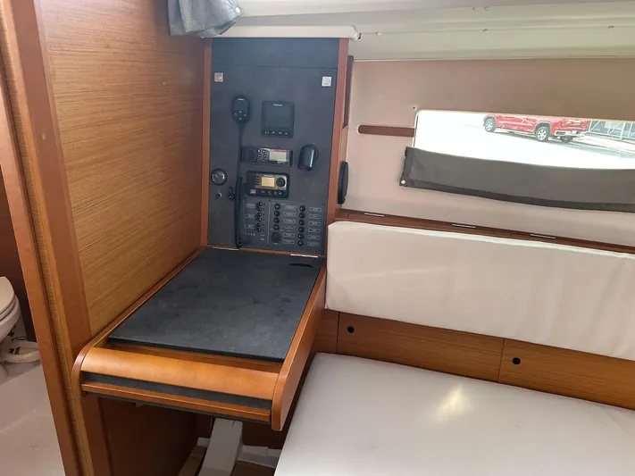  Yacht Photos Pics Interior of 2020 Jeanneau Sun Odyssey 349 yacht with navigation panel and seating area.