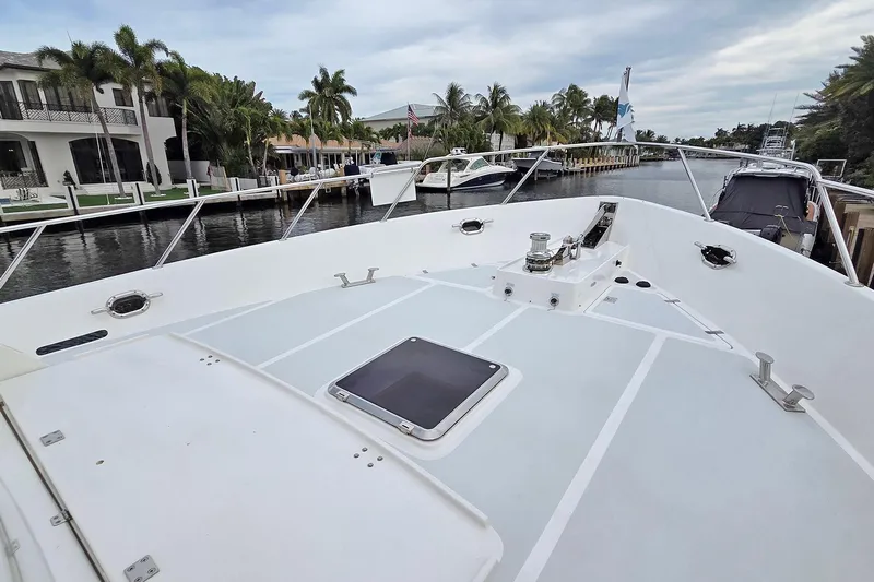 Suertudo Yacht Photos Pics 2020 Outer Reef Yachts 720 Motoryacht bow view, docked near waterfront homes.