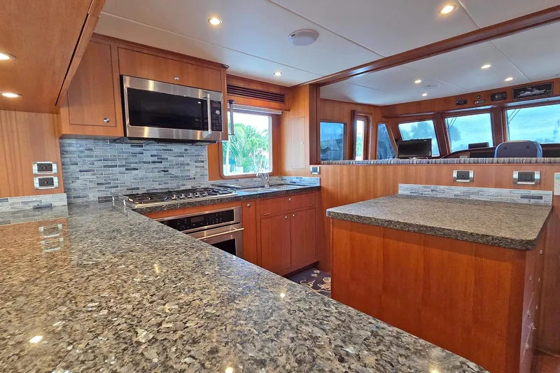 Suertudo Yacht Photos Pics Luxurious kitchen interior of 2020 Outer Reef Yachts 720 Motoryacht with granite countertops.