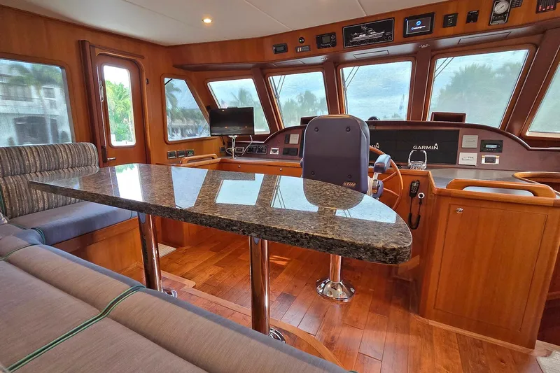 Suertudo Yacht Photos Pics Luxurious interior of 2020 Outer Reef Yachts 720 Motoryacht with granite table and navigation equipment.