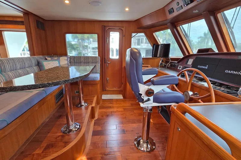 Suertudo Yacht Photos Pics Luxurious 2020 Outer Reef Yachts 720 Motoryacht interior with helm and seating area.