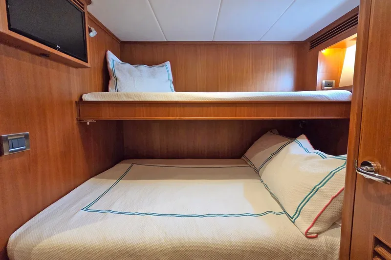 Suertudo Yacht Photos Pics 2020 Outer Reef Yachts 720 Motoryacht cabin with wooden interior and bunk beds.