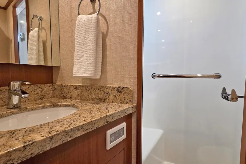 Suertudo Yacht Photos Pics Luxurious bathroom in 2020 Outer Reef Yachts 720 Motoryacht with granite countertop and modern fixtures.