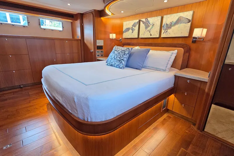 Suertudo Yacht Photos Pics Luxurious bedroom interior of 2020 Outer Reef Yachts 720 Motoryacht with elegant wood finish.