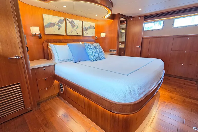 Suertudo Yacht Photos Pics Luxurious bedroom interior of 2020 Outer Reef Yachts 720 Motoryacht with elegant wood finishes.