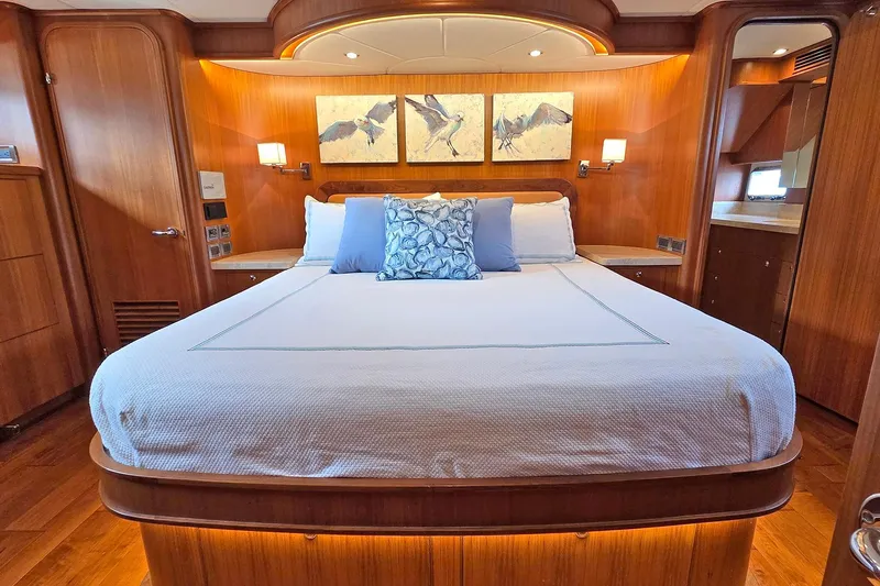 Suertudo Yacht Photos Pics Luxurious bedroom interior of 2020 Outer Reef Yachts 720 Motoryacht with elegant wood finish.