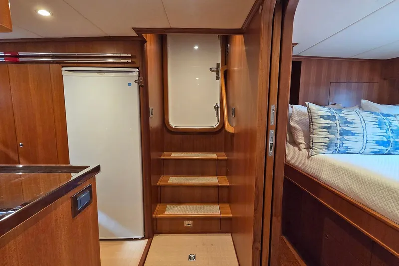 Suertudo Yacht Photos Pics Luxurious interior of 2020 Outer Reef Yachts 720 Motoryacht with wooden finishes and cozy bedroom.