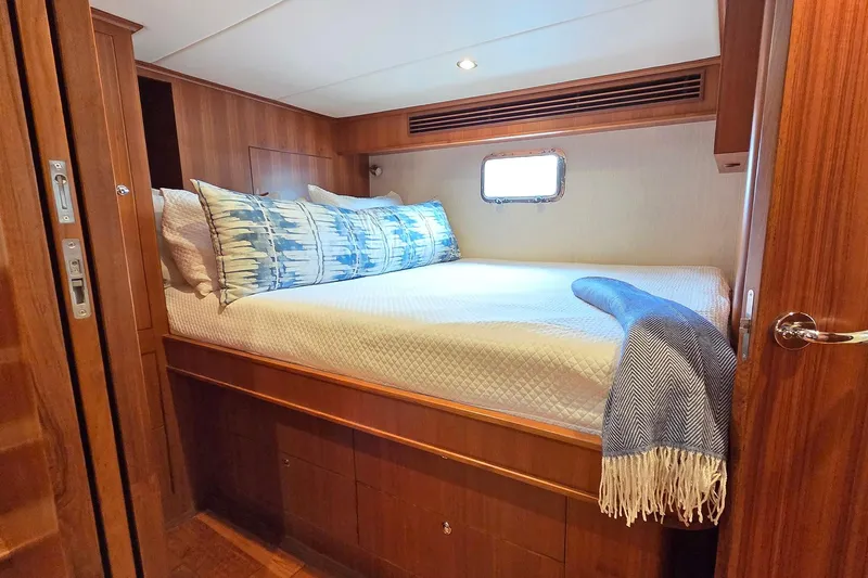 Suertudo Yacht Photos Pics Luxurious cabin interior of 2020 Outer Reef Yachts 720 Motoryacht with cozy bedding.