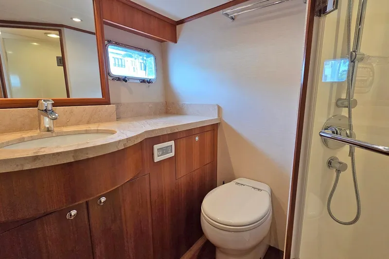 Suertudo Yacht Photos Pics Luxurious bathroom in 2020 Outer Reef Yachts 720 Motoryacht with modern fixtures and wood accents.