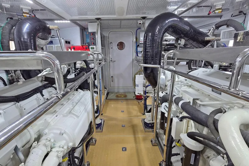 Suertudo Yacht Photos Pics Engine room of 2020 Outer Reef Yachts 720 Motoryacht, featuring dual engines and polished metal railings.