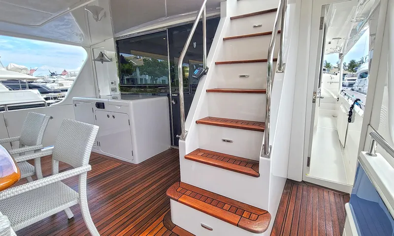 Suertudo Yacht Photos Pics Luxurious 2020 Outer Reef Yachts 720 Motoryacht interior with elegant wooden stairs and seating.