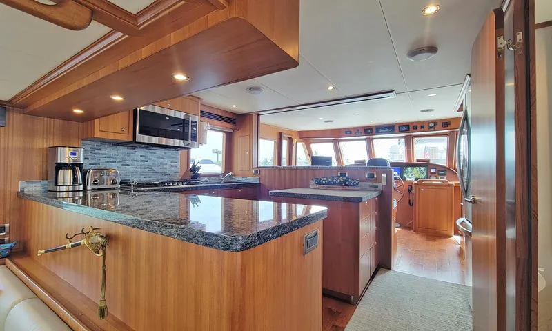 Suertudo Yacht Photos Pics Luxurious kitchen interior of 2020 Outer Reef Yachts 720 Motoryacht with modern appliances.