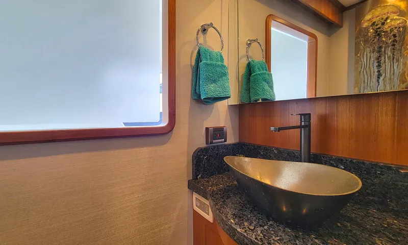Suertudo Yacht Photos Pics Luxurious bathroom in 2020 Outer Reef Yachts 720 Motoryacht with modern sink and teal towels.