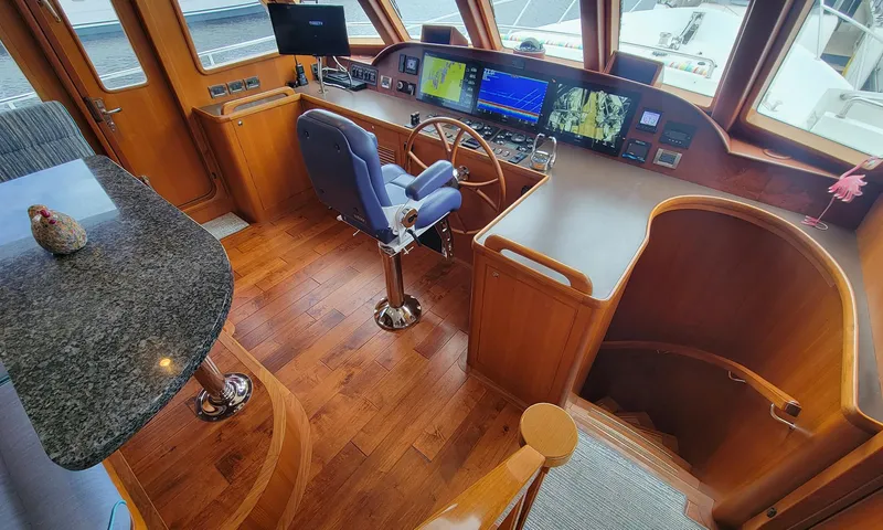 Suertudo Yacht Photos Pics Pilothouse of 2020 Outer Reef Yachts 720 Motoryacht with wood flooring and navigation equipment.