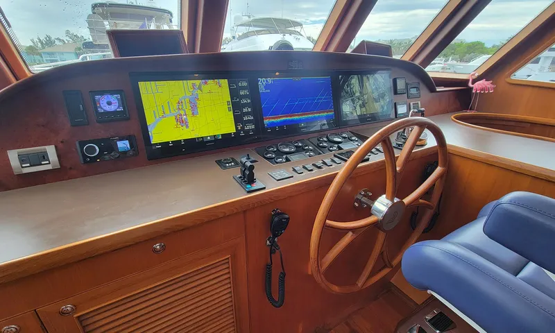 Suertudo Yacht Photos Pics Pilothouse of 2020 Outer Reef Yachts 720 Motoryacht with navigation screens and wooden steering wheel.