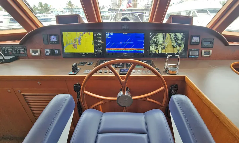Suertudo Yacht Photos Pics Pilothouse of 2020 Outer Reef Yachts 720 Motoryacht with navigation screens and wooden steering wheel.