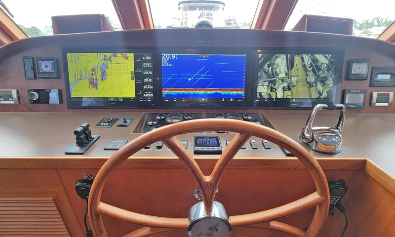 Suertudo Yacht Photos Pics Helm of 2020 Outer Reef Yachts 720 Motoryacht with navigation displays and wooden steering wheel.