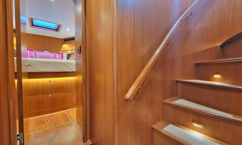 Suertudo Yacht Photos Pics Luxurious interior of 2020 Outer Reef Yachts 720 Motoryacht with wooden stairs and cozy cabin.