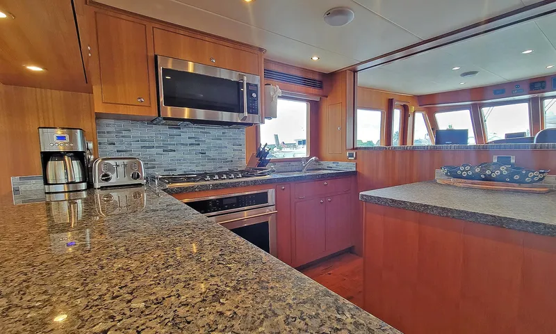 Suertudo Yacht Photos Pics Luxurious kitchen interior of 2020 Outer Reef Yachts 720 Motoryacht with modern appliances.