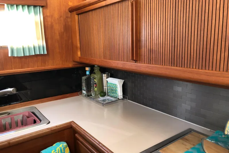  Yacht Photos Pics 1988 Tollycraft 40 Sundeck Motor Yacht kitchen with wood cabinetry and modern backsplash.
