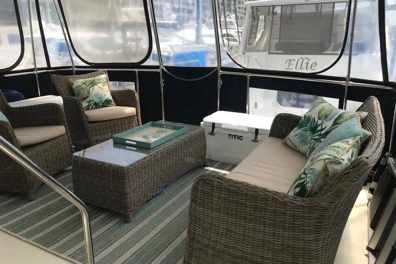  Yacht Photos Pics 1988 Tollycraft 40 Sundeck Motor Yacht interior with wicker seating and tropical cushions.