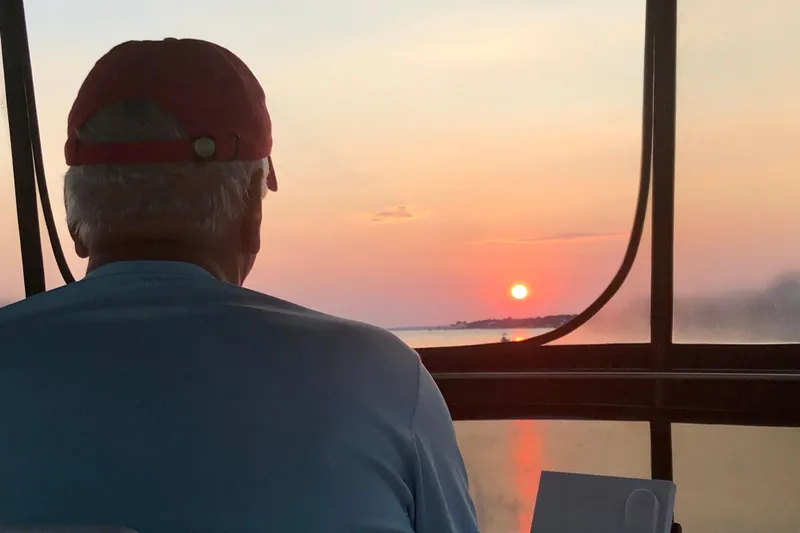  Yacht Photos Pics Man enjoying sunset view from 1988 Tollycraft 40 Sundeck Motor Yacht.