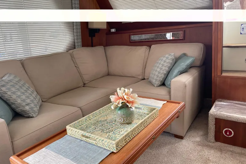  Yacht Photos Pics Interior of 1988 Tollycraft 40 Sundeck Motor Yacht with beige sofa and decorative pillows.