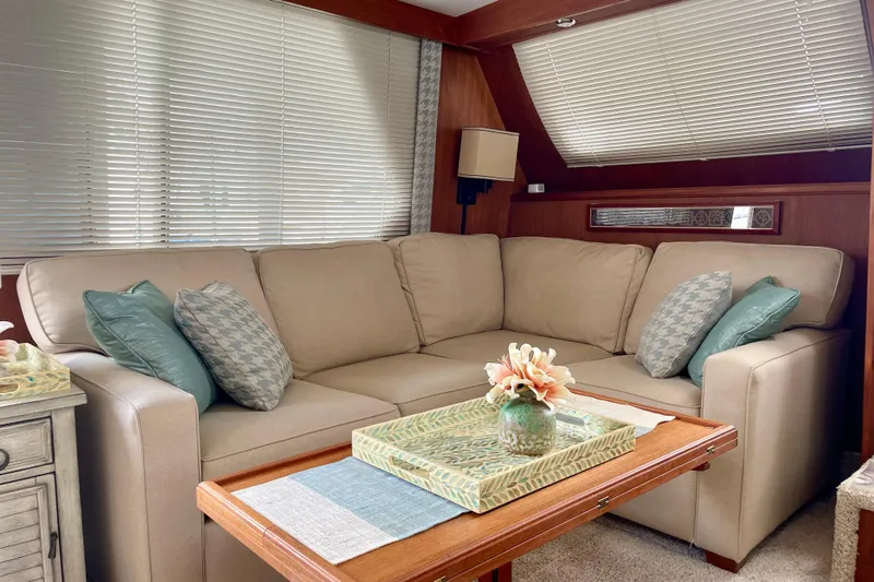  Yacht Photos Pics Luxurious interior of 1988 Tollycraft 40 Sundeck Motor Yacht with beige sofa and decorative pillows.