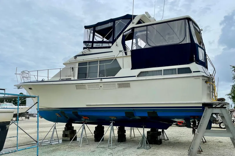  Yacht Photos Pics 1988 Tollycraft 40 Sundeck Motor Yacht on dry dock, featuring blue and white exterior.