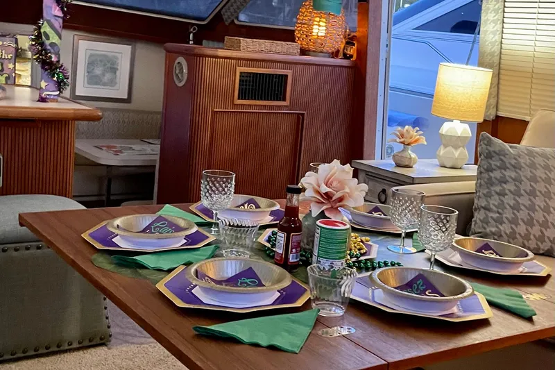  Yacht Photos Pics Elegant dining setup inside 1988 Tollycraft 40 Sundeck Motor Yacht, featuring decorative tableware and ambient lighting.