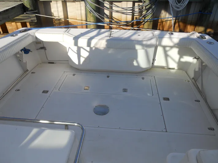 Fish Tales Yacht Photos Pics Spacious deck of 2000 Boston Whaler 34 Defiance boat, featuring clean white seating and storage.
