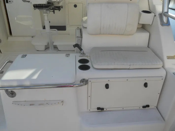 Fish Tales Yacht Photos Pics Boston Whaler 34 Defiance 2000 interior with seating, storage, and cup holders.
