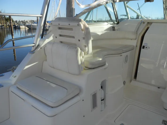 Fish Tales Yacht Photos Pics Interior of 2000 Boston Whaler 34 Defiance boat with white seating and helm area.