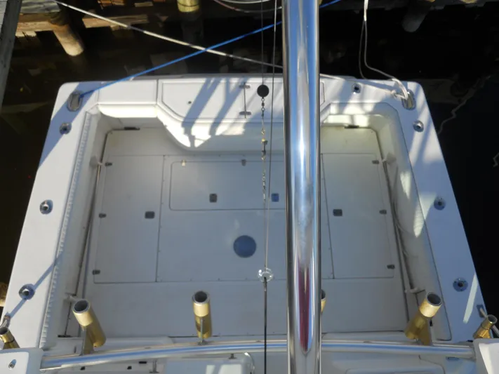 Fish Tales Yacht Photos Pics Boston Whaler 34 Defiance 2000 boat deck with rod holders and storage compartments.