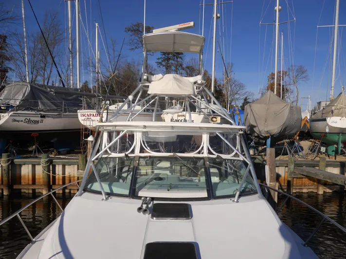 Fish Tales Yacht Photos Pics Boston Whaler 34 Defiance 2000 boat docked at marina with sailboats in background.