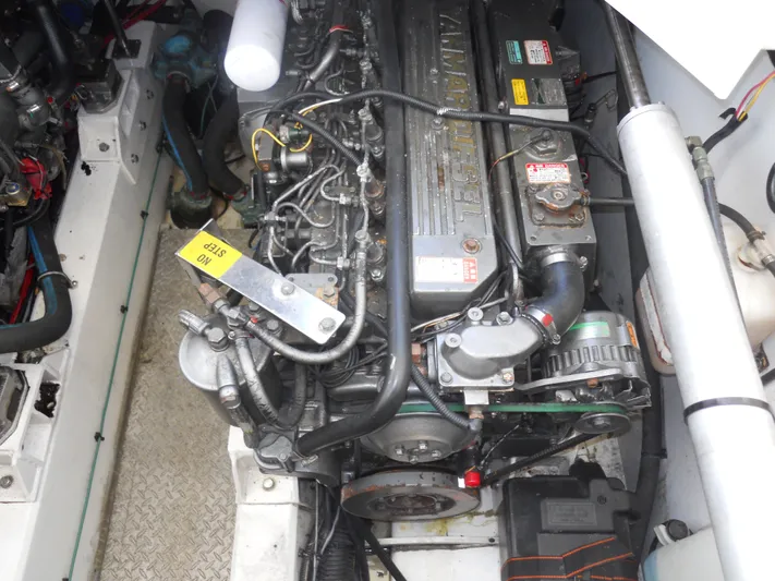 Fish Tales Yacht Photos Pics Engine compartment of a 2000 Boston Whaler 34 Defiance boat, showcasing detailed machinery.