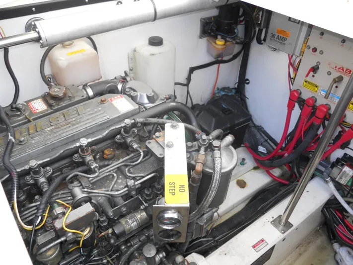 Fish Tales Yacht Photos Pics Engine compartment of a 2000 Boston Whaler 34 Defiance, featuring diesel engine and electrical components.