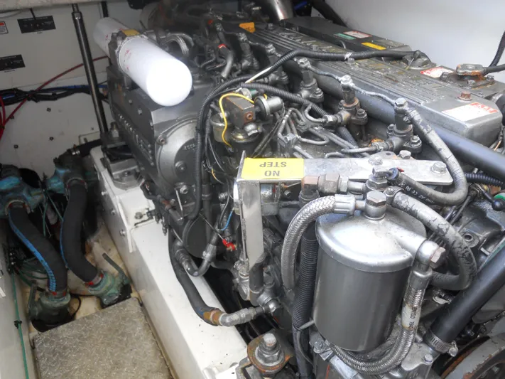 Fish Tales Yacht Photos Pics Engine compartment of a 2000 Boston Whaler 34 Defiance boat, showcasing detailed machinery.
